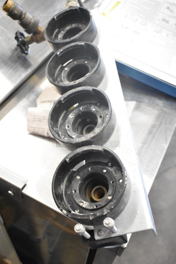 Various items including an Everpure 4000 water filter head in good condition, arranged on a metal surface.