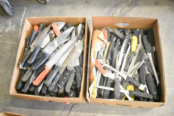 Cardboard boxes containing 160 sharpened stainless steel knives, including chef knives with black, red, and yellow handles.