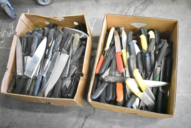 Two boxes of 230 sharpened stainless steel knives, varying types including chef knives, black and colored handles.