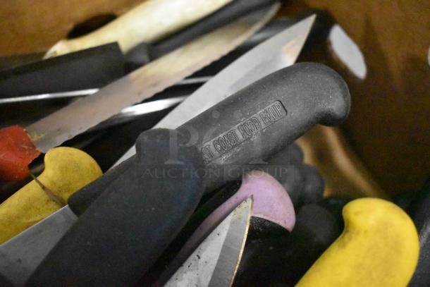 Box of 230 sharpened stainless steel knives with colored handles, including chef knives. Handle marked "ST COAST FOOD EQUIP."