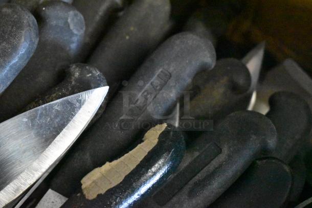 Sharpened stainless steel knives with black handles, including chef knife; visible "GREBAN" marking on handles.