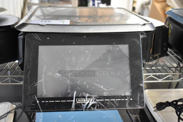 2019 Hobart HTi-LH3 commercial countertop scale, tested and working. Visible wear on screen. Model and brand name displayed.