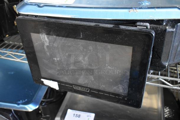 2023 Hobart HTi-7LH4W countertop scale, black, tested and working, 120/208-240V, 1 Phase, minor wear visible.