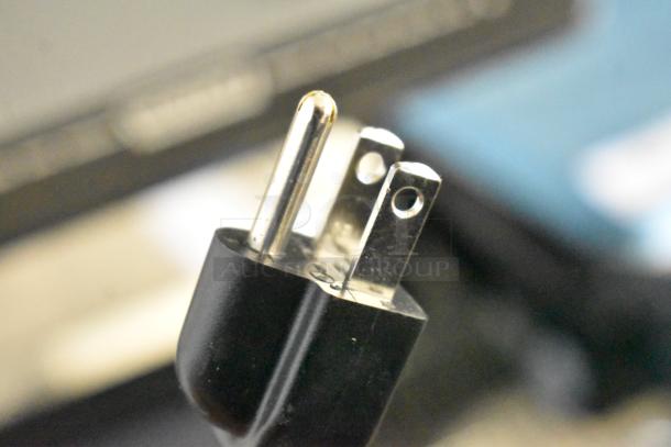 Close-up of a 3-prong power plug for a 2017 Hobart HTi-7LH26 commercial countertop scale.