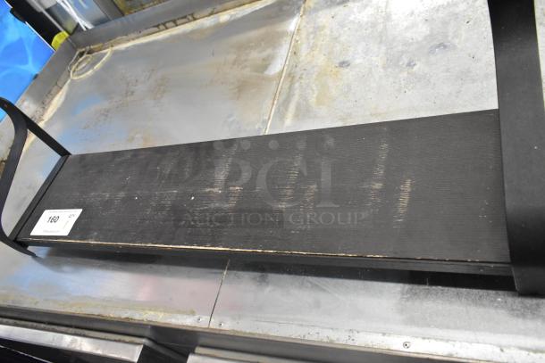 Black wall mount shelf, metal brackets, visible scratches, auction tag "160" attached, used condition.