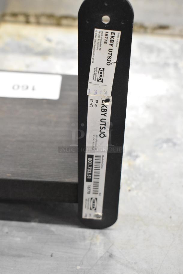 IKEA EKBY UTSJÖ wall mount shelf, 19 cm, black, model 16778 with tags indicating dimensions and product details.