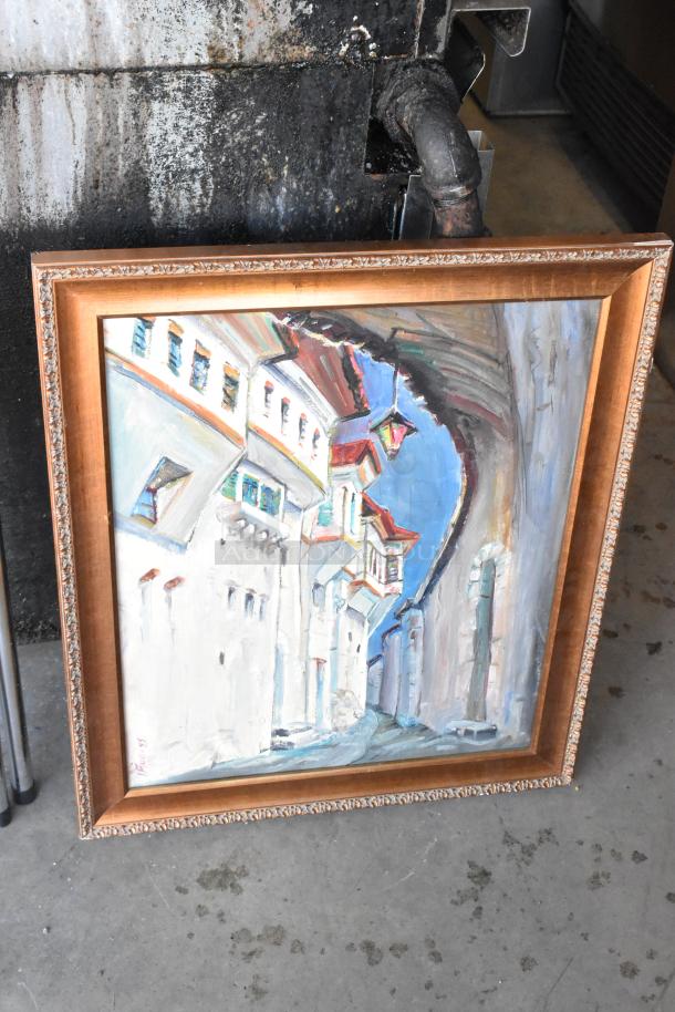 Framed painting depicting an abstract street scene. Ornate wooden frame, artist's signature visible. Good condition.