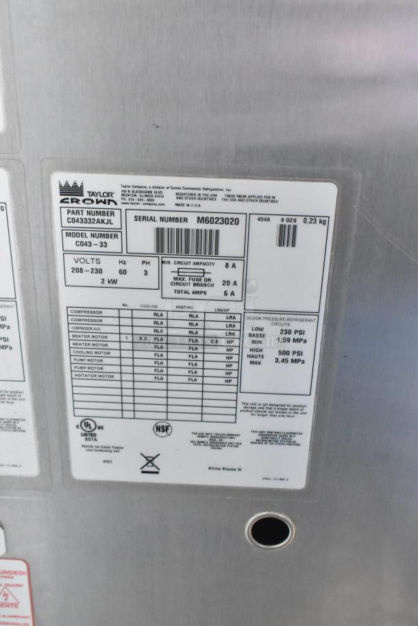 Label on Taylor C043-33 frozen custard machine, showing part number, model, power specs, and certification marks.