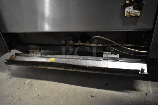 Montague Vectaire gas-powered vertical broiler, stainless steel, visible wear, Montague 150-year emblem on front panel.