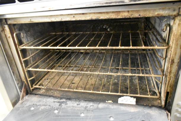 Montague Vectaire commercial gas upright vertical broiler, showing interior rack and signs of use.