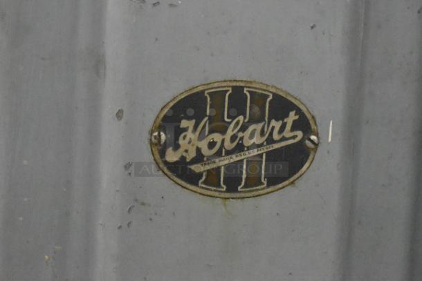 Hobart Commercial Floor Style Meat Saw badge, featuring the Hobart logo in vintage style, indicating brand authenticity.