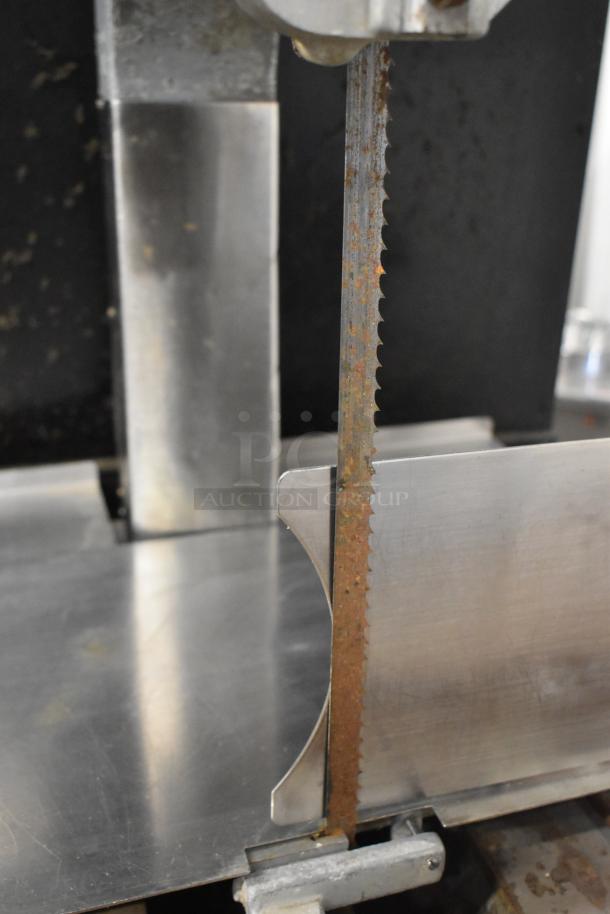 Hobart commercial floor-style meat saw showing a rusted blade, stainless steel construction, used condition.