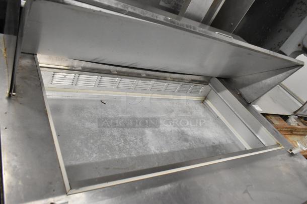 Beverage Air SPE48-18M sandwich prep table, stainless steel, open interior, moderate wear, on casters, 115V, 1 Phase.