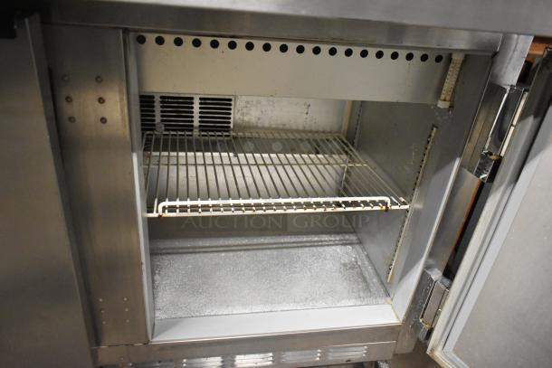 Beverage Air SPE48-18M prep table, stainless steel, interior shelving, commercial grade, on casters, 115V, good condition.