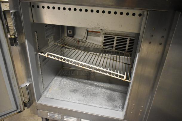 Beverage Air SPE48-18M sandwich salad prep table, stainless steel, commercial casters, interior view, 115 volts, used condition.