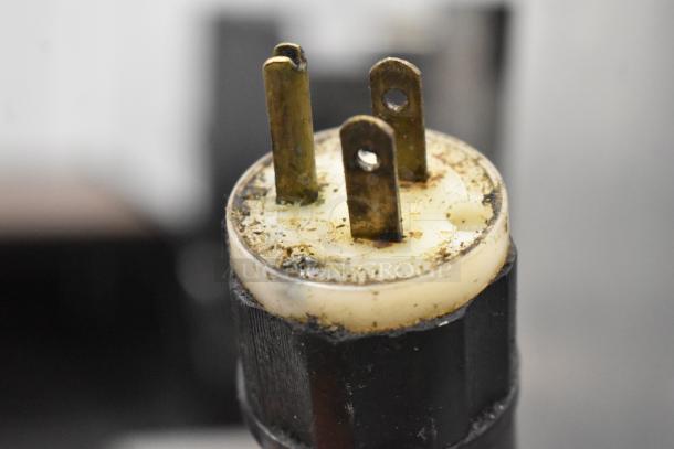 The image shows a close-up of an electrical plug for the Avantco 177HPI1836 Heated Holding Cabinet. The prongs appear slightly worn.