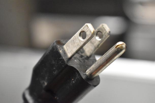 Close-up of the power plug for the Avantco 178APT48HC Commercial Sandwich Salad Prep Table, 115 Volts, 1 Phase.