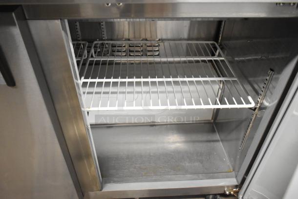 Avantco 178APT48HC commercial prep table interior with wire shelves, stainless steel finish, used condition, on casters.