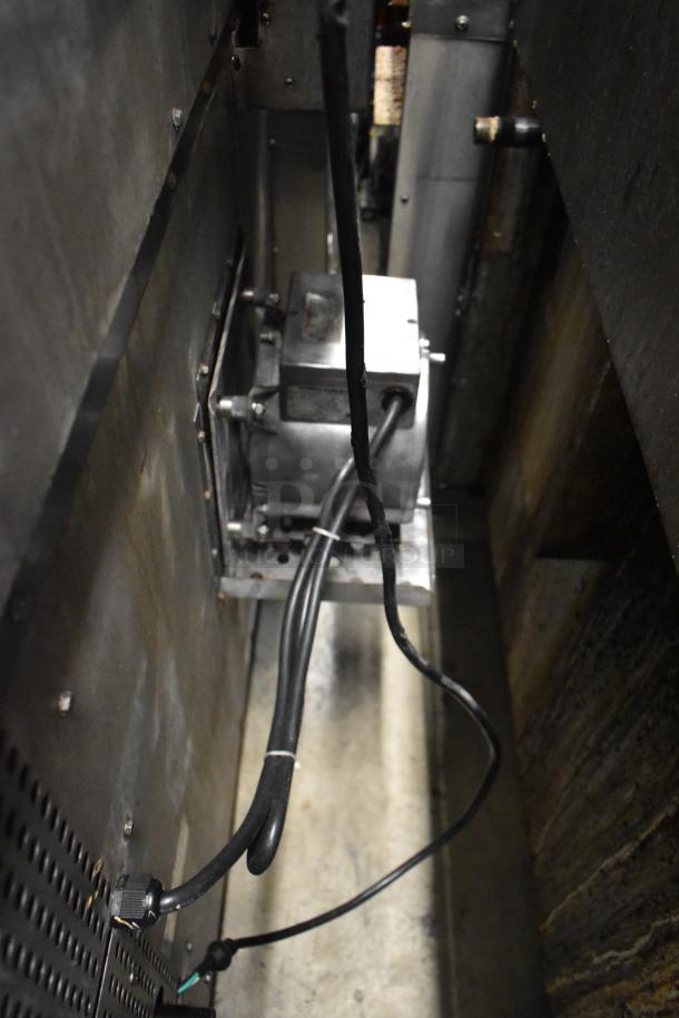 Commercial natural gas convection oven interior view, showing metal components and wiring. Model 351FGC100N by Cooking Performance Group.