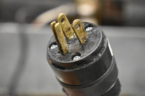 Close-up of a three-prong plug attached to the Avantco 178SSUC48RHC commercial cooler. 115 Volts, 1 Phase.