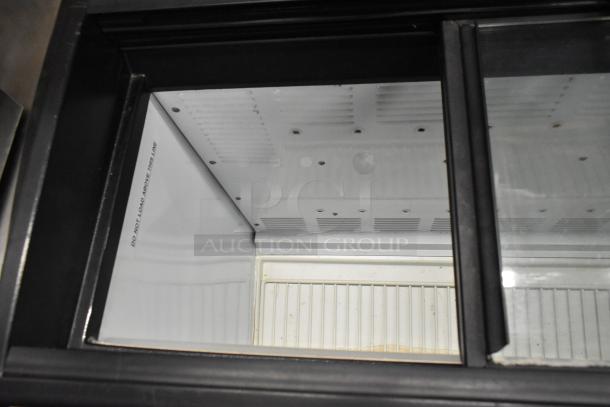 Beverage Air EZA84 commercial chest freezer interior, model EZA84, 115 volts, 1 phase. "Do not load above this line" marking.