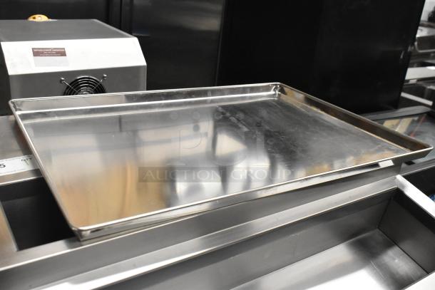 Full-size metal baking pans, set of 20, in good condition, reflecting finish, for auction at 20 times bid value.