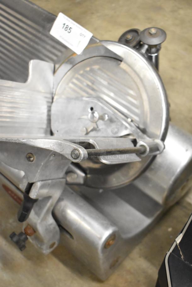 Globe Commercial Countertop Meat Slicer, includes blade sharpener, 115 volts, 1 phase. Good condition, metal construction.