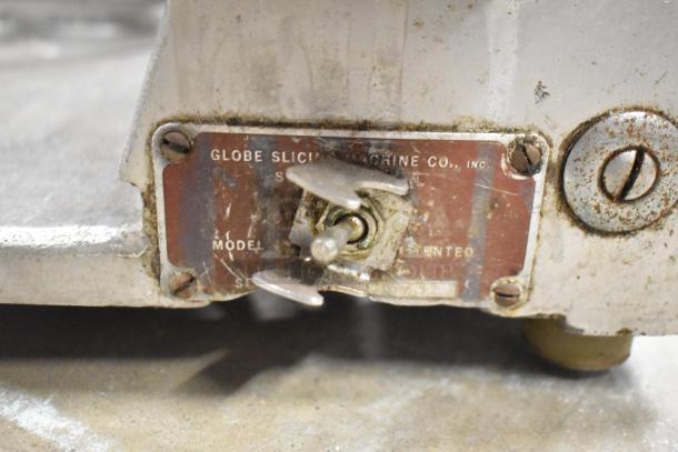 Globe Commercial Countertop Meat Slicer with Blade Sharpener, visible wear, 115 Volts, 1 Phase, model and serial details shown.