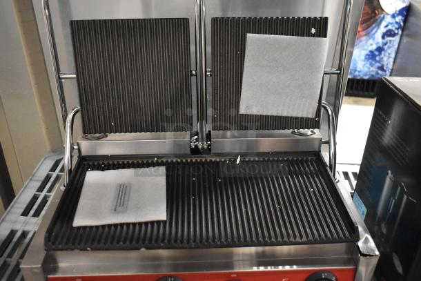 Brand new Avantco 177PG400 dual panini grill with grooved plates, 19 5/8" x 9 1/8" cooking surface, 120V, 1 Phase.