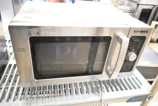 Solwave Commercial Countertop Microwave Oven with digital controls, stainless steel exterior, and visible wear.