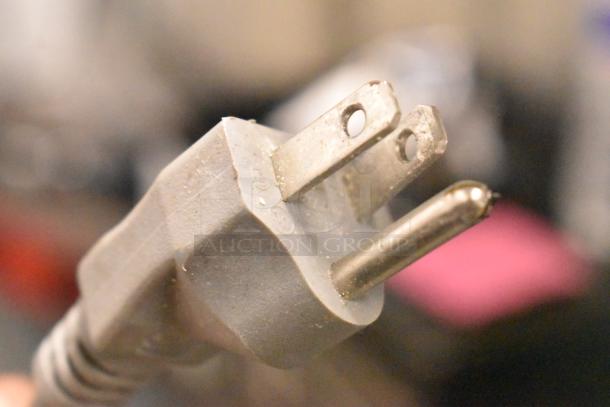 Close-up of a power plug from a Solwave Commercial Countertop Microwave Oven. Plug shows signs of usage.
