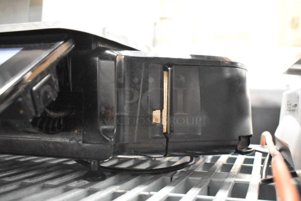 2017 Hobart HTi-7LH26 countertop scale, black, in working condition, visible power cord, industrial shelving.