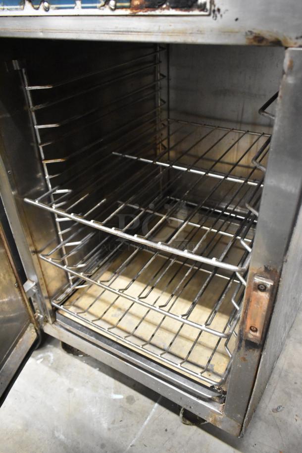 Alto Shaam 1000-TH commercial oven on casters; lower door open, upper door does not open; 208/240 volts; interior racks visible.