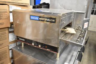 Lincoln Impinger 1302 electric conveyor pizza oven, 240 volts, 1 phase, stainless steel exterior, visible controls, used condition.