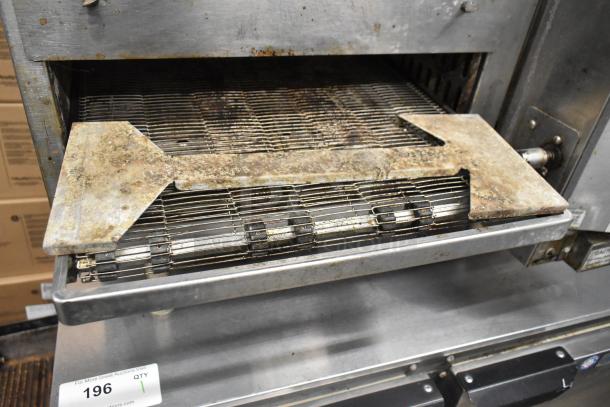 Lincoln Impinger 1302 electric conveyor pizza oven in used condition, 240 volts, 1 phase, showing wear on conveyor.