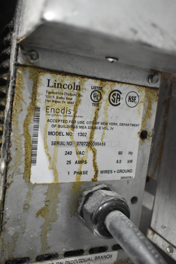 Lincoln Impinger 1302 conveyor pizza oven label showing model number, power specifications, certification stamps, and serial number.