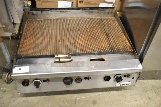 Garland commercial countertop gas-powered ribbed griddle. Rust present; functional knobs; Garland label visible.
