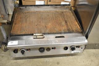 Garland commercial countertop gas-powered ribbed griddle. Rust present; functional knobs; Garland label visible.