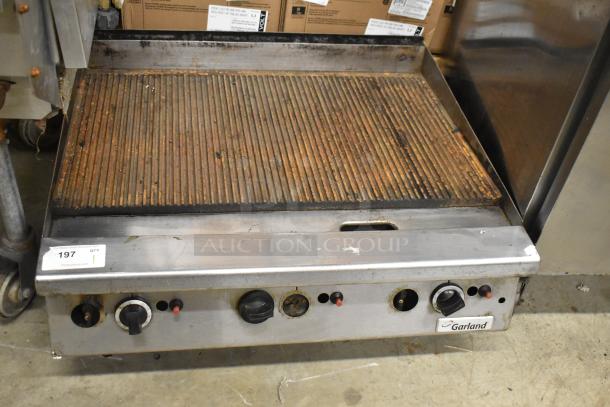 Garland Commercial Gas Powered Ribbed Griddle, countertop model, used condition, features control knobs and Garland logo.