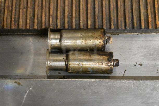 Garland Commercial Countertop Gas Ribbed Griddle, showing ribbed cooking surface and used metal components.