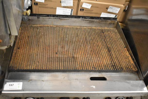 Garland Commercial Countertop Gas-Powered Ribbed Griddle, showing used condition with visible ribbed surface and control knobs.