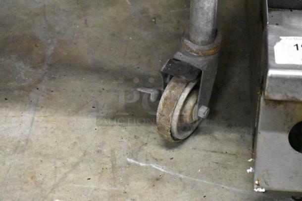 MagiCater LPAGA60 portable charbroiler grill on commercial caster, showing signs of wear.