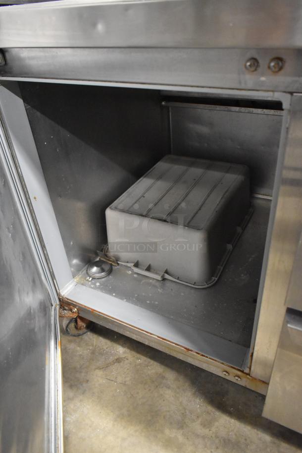 Continental CPA60 pizza prep table, 2 drawers/doors, commercial casters, interior view showcasing equipment condition.