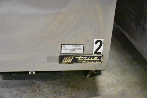 True TSSU-27-12M-B commercial sandwich salad prep table; features Bain Marie top, commercial casters, 115 volts. Visible labels.