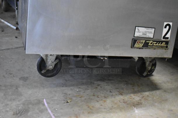 True TSSU-27-12M-B prep table with commercial casters. Model label visible. Used condition. 115 volts, 1 phase.