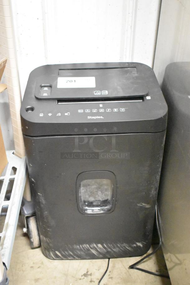 Staples ST62157 micro-cut shredder, 120 volts, 1 phase, black exterior, visible power cord, slight surface wear.