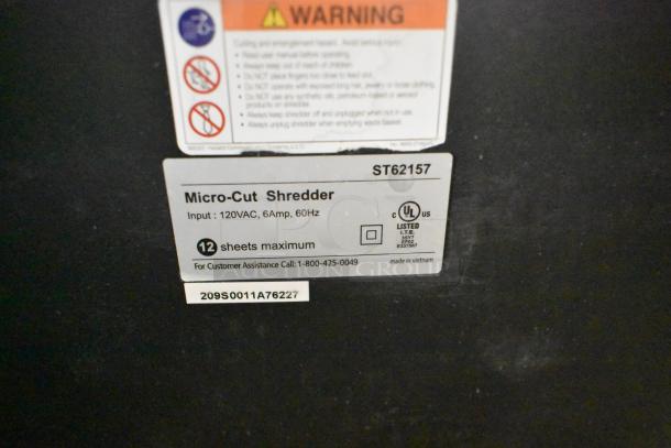 Staples ST62157 Micro-Cut Shredder label, 120V, 1 Phase, 12 sheets max, UL listed, made in Vietnam.