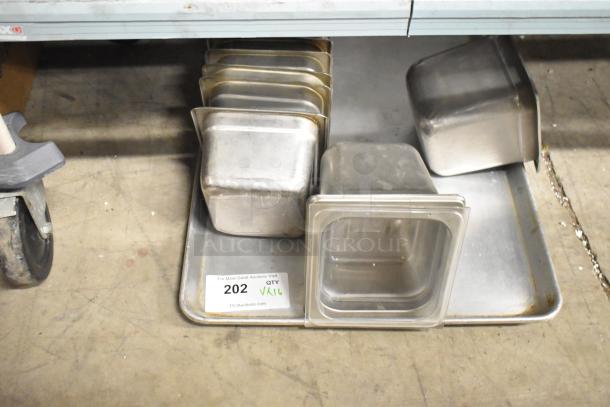 16 various items including stainless steel drop-in bins and metal baking pan shown. Includes auction label "202 QTY VAR" from PCI Auctions.