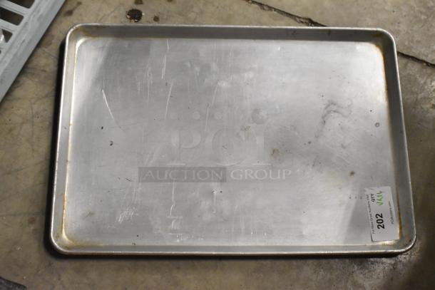Set of 16 stainless steel drop-in bins and metal baking pan, auction lot 202, used condition with visible wear.