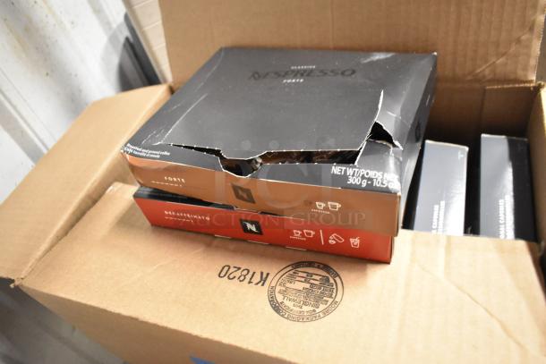 Box of Nespresso coffee grounds, featuring Forte and Decaffeinato varieties. Forte box is slightly damaged.
